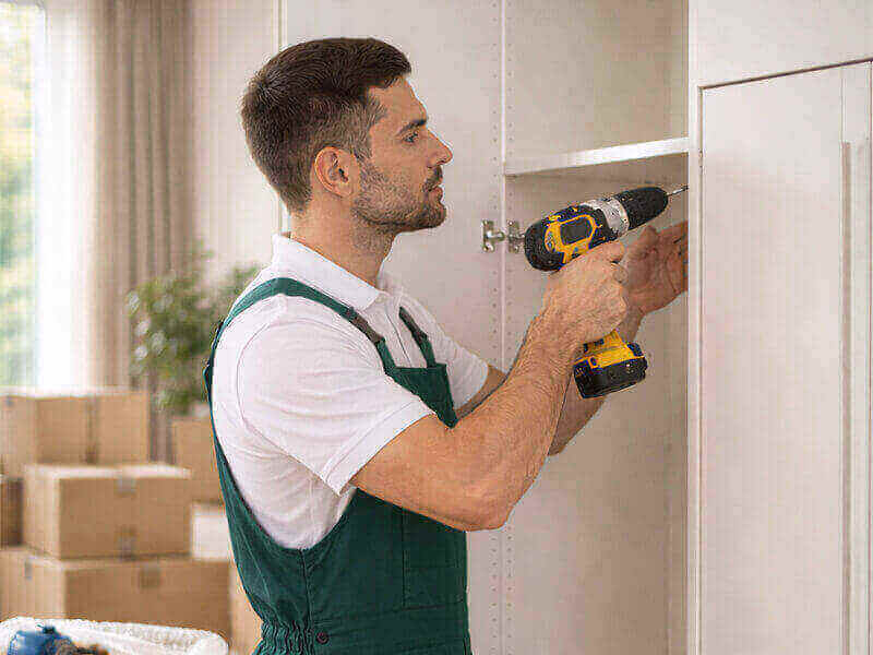 operatore durante lo smontaggio di un mobile